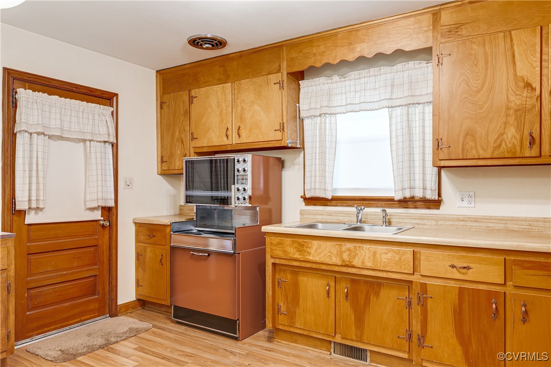 3307 Walnut Street Hopewell, VA 23860 - Photo 19 of 38 a kitchen with stainless steel appliances granite countertop a sink and a stove next to a window