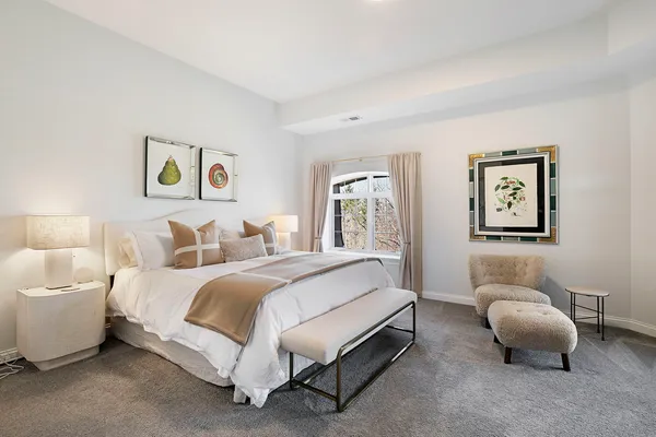 a spacious bedroom with a bed and a couch
