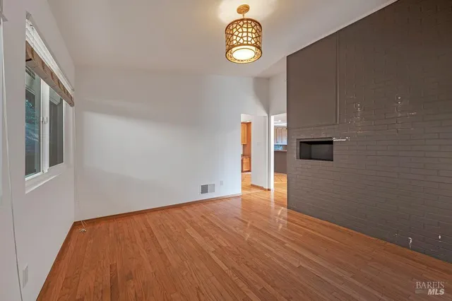 a view of empty room with a kitchen