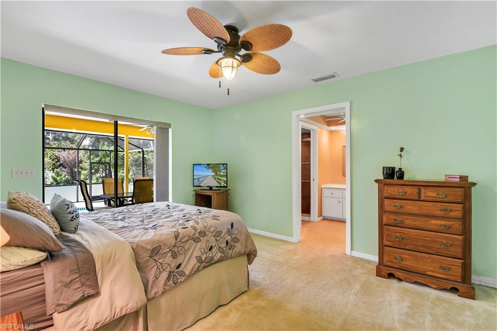 8444 Lemon Road Fort Myers, FL 33967 - Photo 17 of 30 a bedroom with a bed and a chandelier