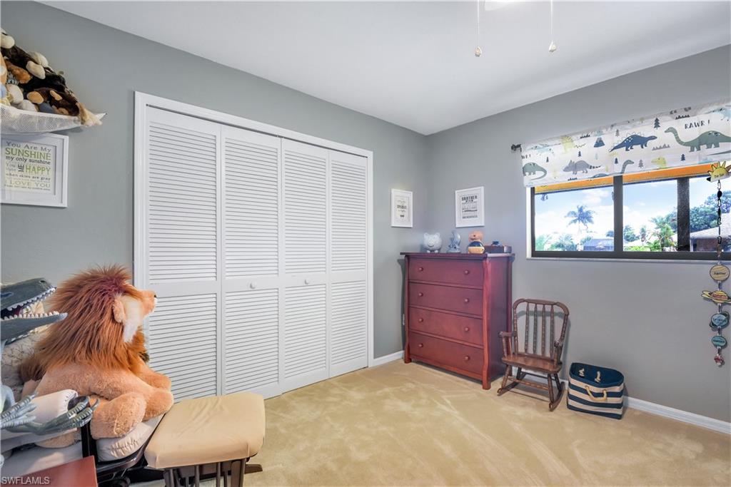 8444 Lemon Road Fort Myers, FL 33967 - Photo 24 of 30 a bedroom with a bed and a dresser in it
