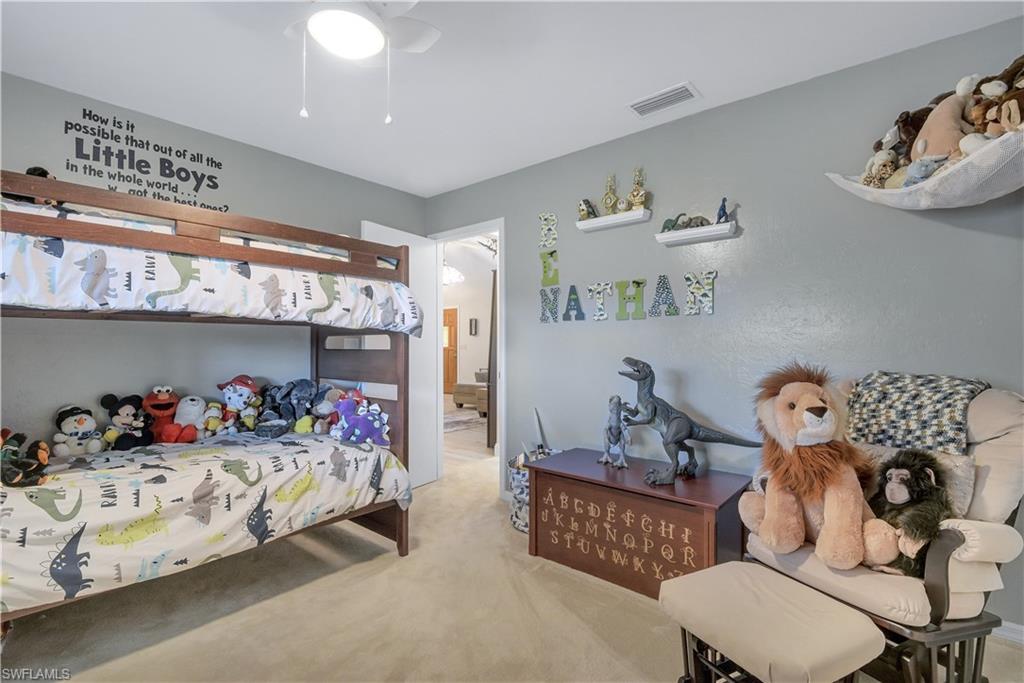8444 Lemon Road Fort Myers, FL 33967 - Photo 25 of 30 a bedroom with furniture and a wooden floor