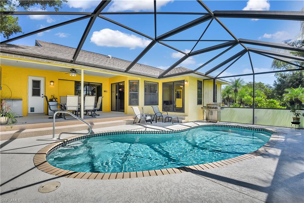 8444 Lemon Road Fort Myers, FL 33967 - Photo 27 of 30 a view of a backyard with table and chairs under an umbrella