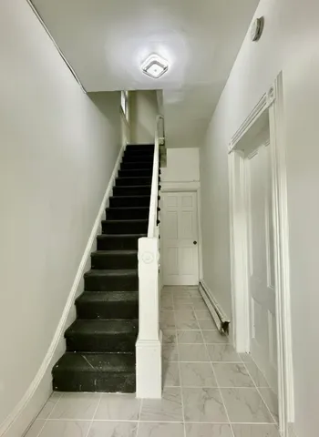 a view of entryway and hall with wooden floor