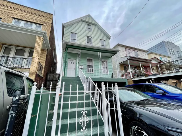 a view of a house with pool and sitting area