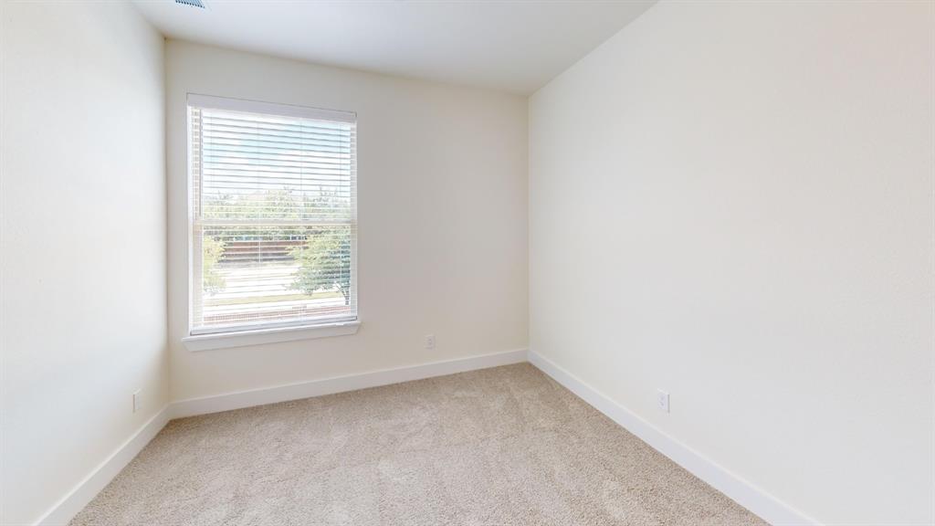 313 Buck Ridge Drive Frisco, TX 75068 - Photo 12 of 20 Bright room featuring a single window with blinds, neutral-toned carpet, and white baseboards