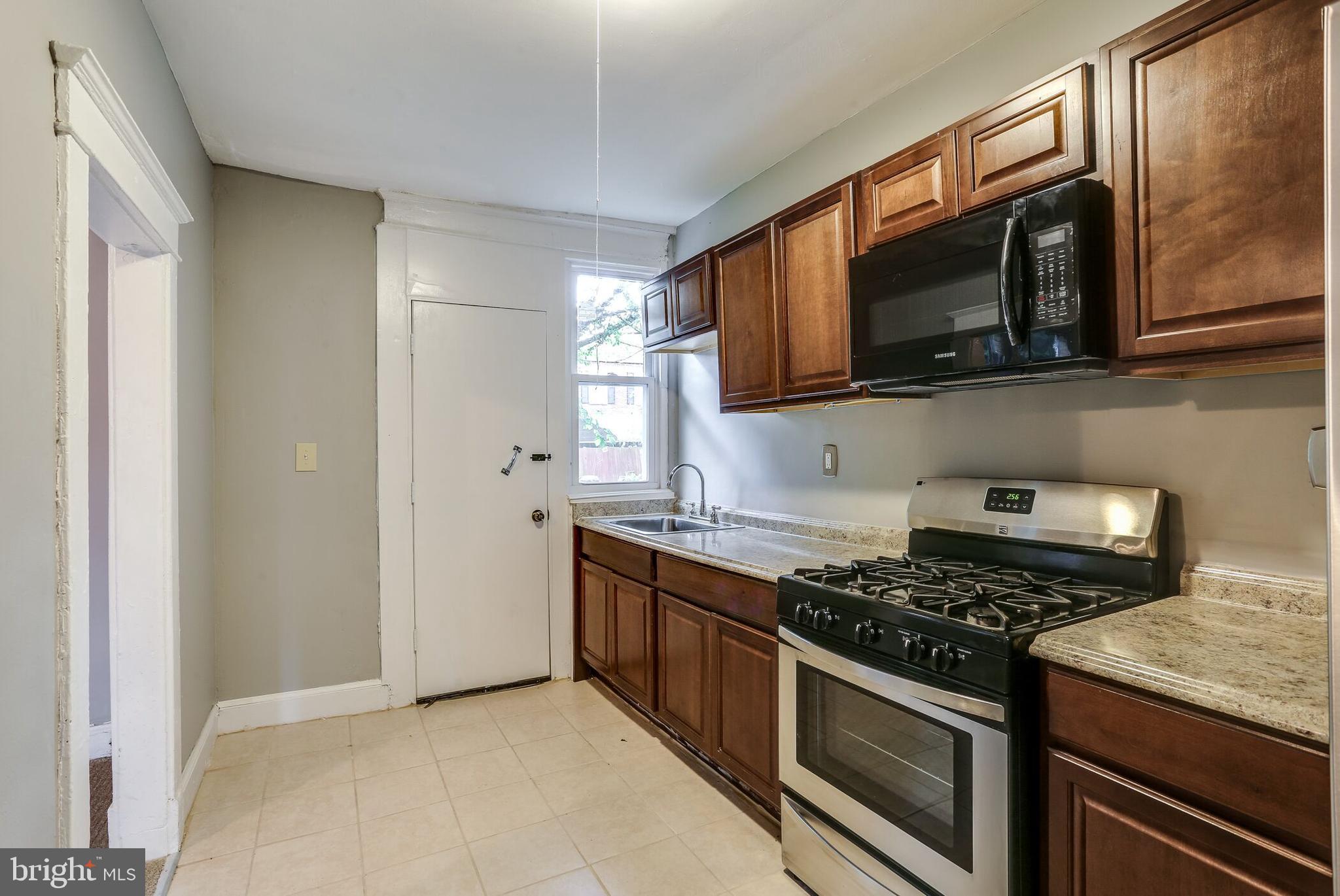 713 Springfield Avenue Baltimore, MD 21212 - Photo 11 of 28 a kitchen with stainless steel appliances granite countertop a stove microwave and sink