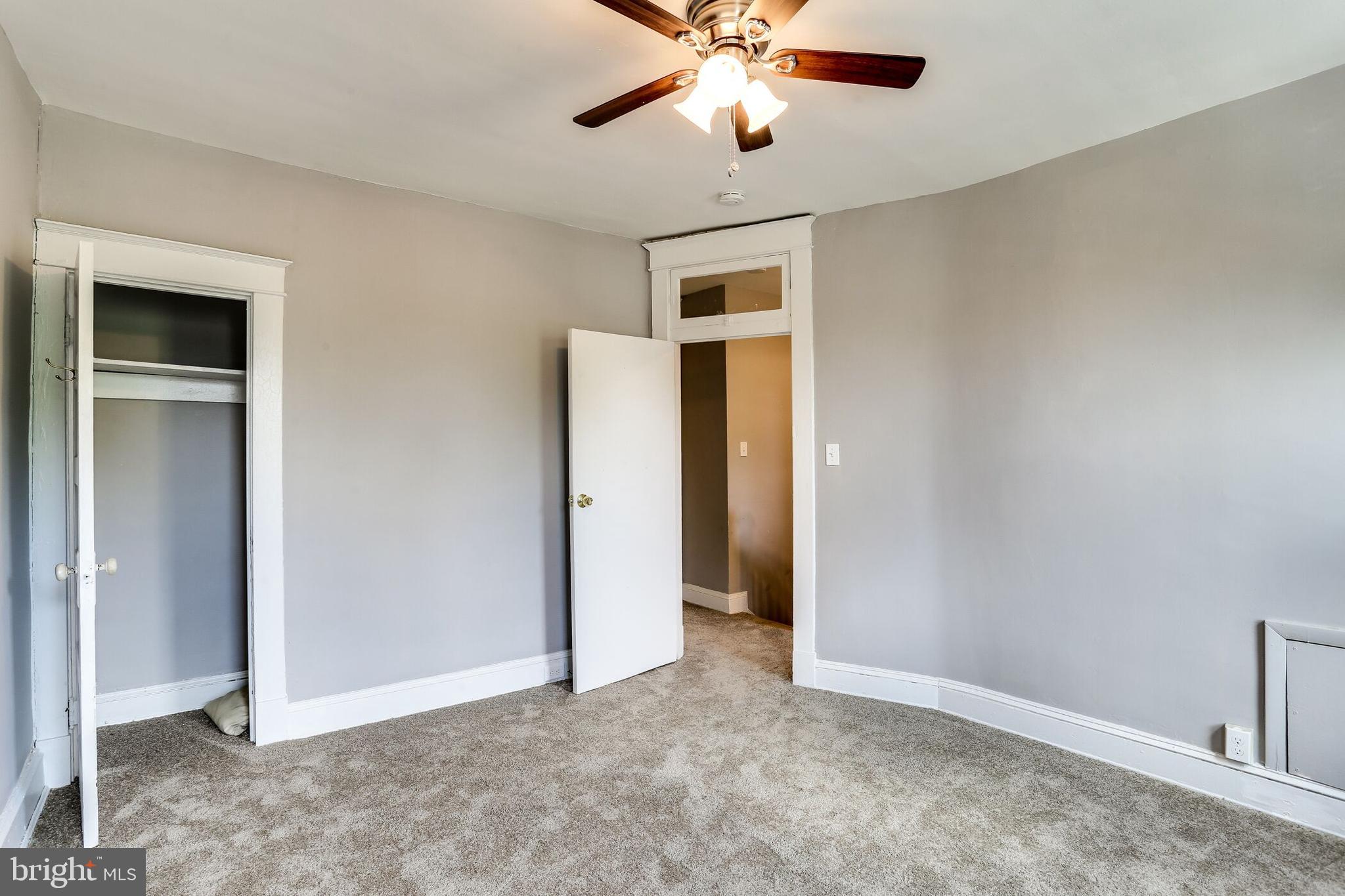 713 Springfield Avenue Baltimore, MD 21212 - Photo 13 of 28 an empty room with closet and a chandelier fan