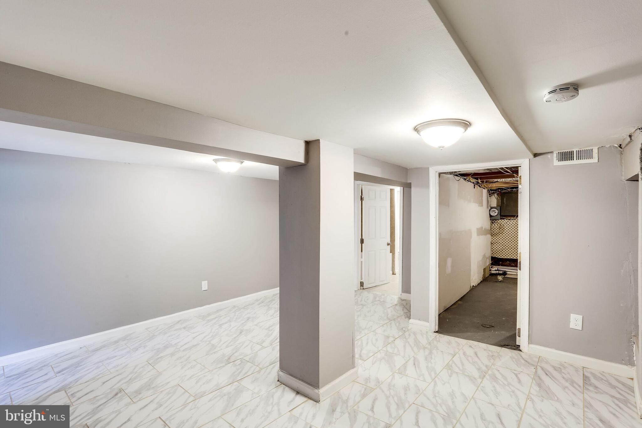 713 Springfield Avenue Baltimore, MD 21212 - Photo 20 of 28 a view of hallway with wooden floor and a living room