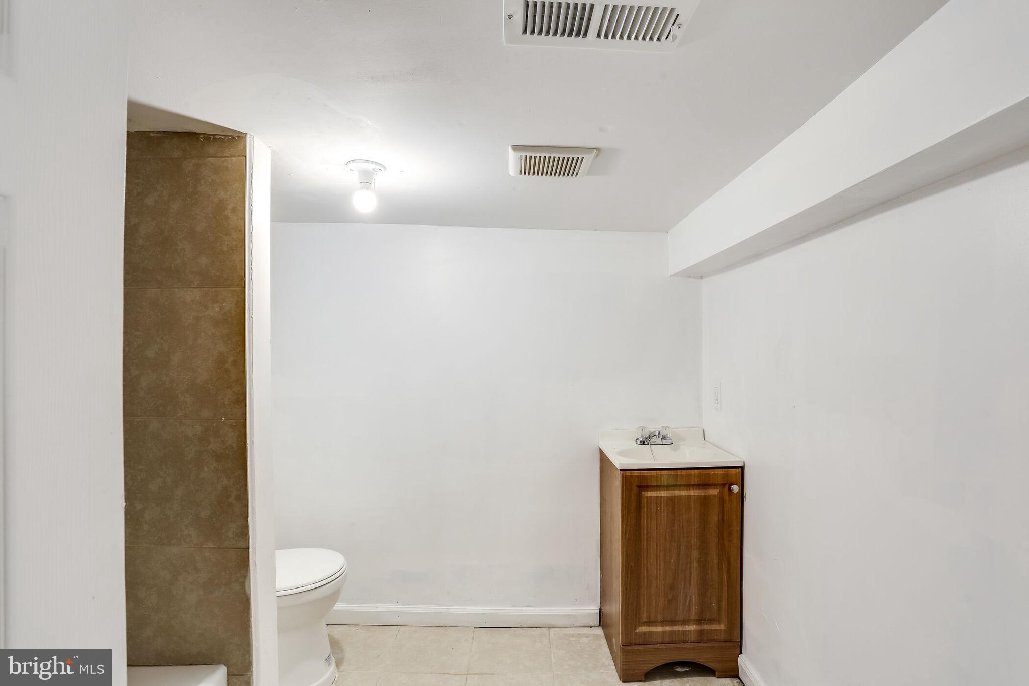 713 Springfield Avenue Baltimore, MD 21212 - Photo 23 of 28 a bathroom with a toilet and a mirror