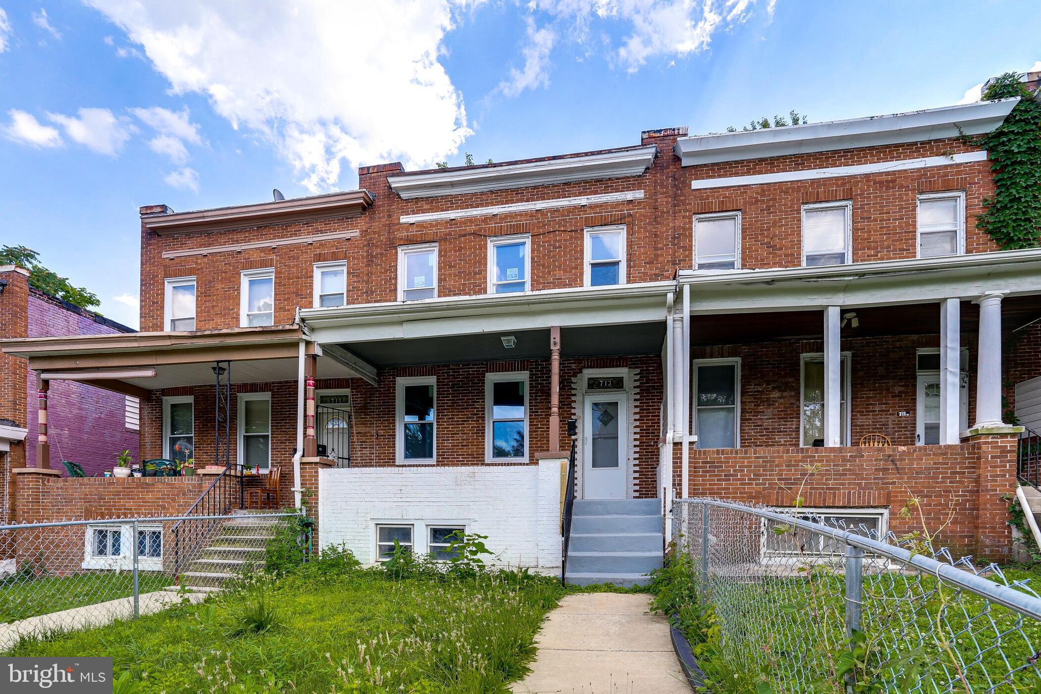 713 Springfield Avenue Baltimore, MD 21212 - Photo 3 of 28 front view of a brick house with a yard