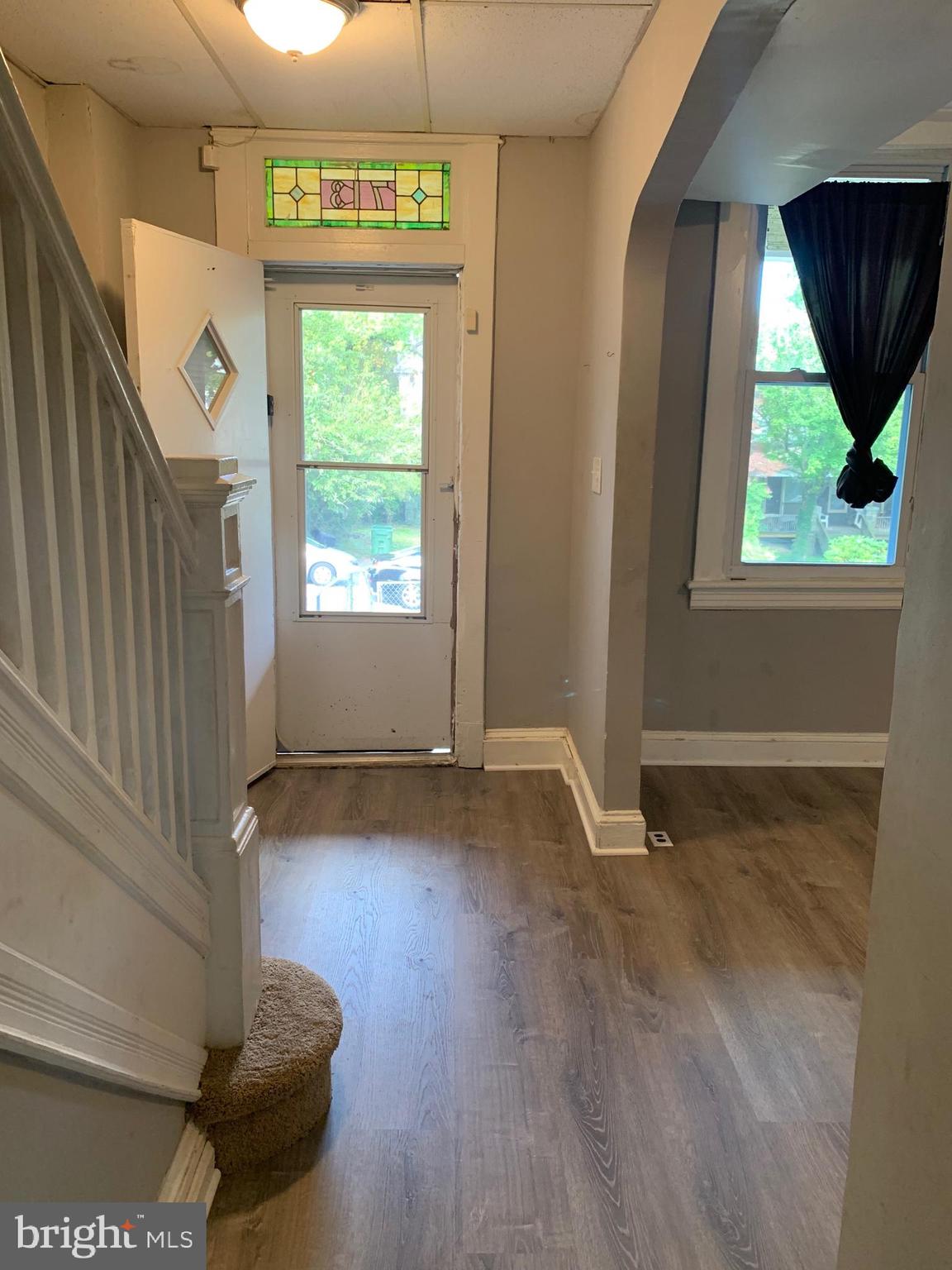 713 Springfield Avenue Baltimore, MD 21212 - Photo 6 of 28 a view of a livingroom with a window and wooden floor