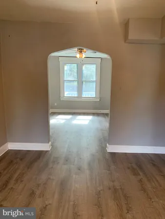 a view of a small space with wooden floor and a window