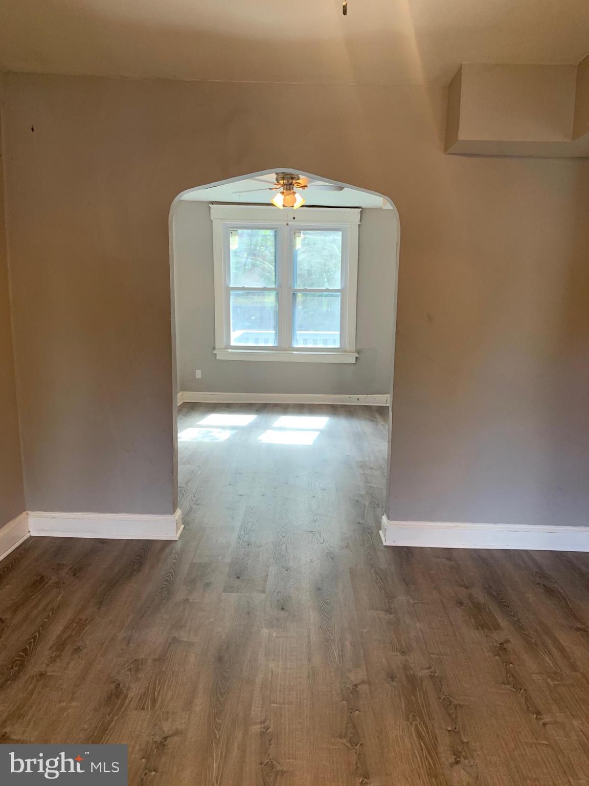 713 Springfield Avenue Baltimore, MD 21212 - Photo 8 of 28 a view of a small space with wooden floor and a window