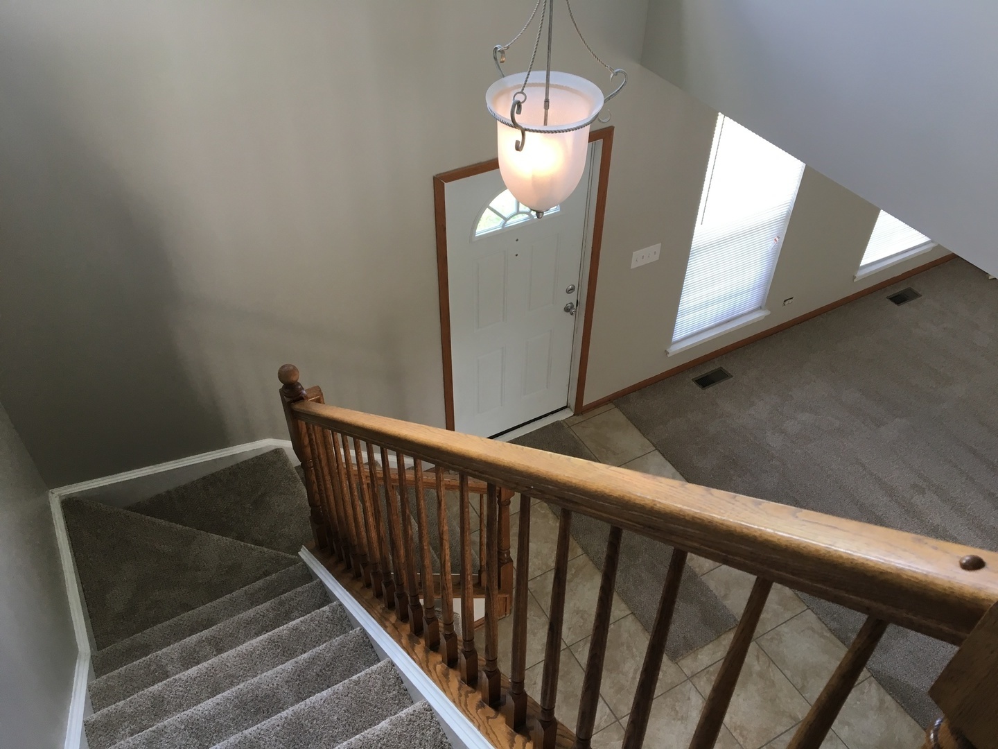 Undisclosed Address Round Lake, IL 60073 - Photo 20 of 29 a view of a hallway with wooden floor and stairs