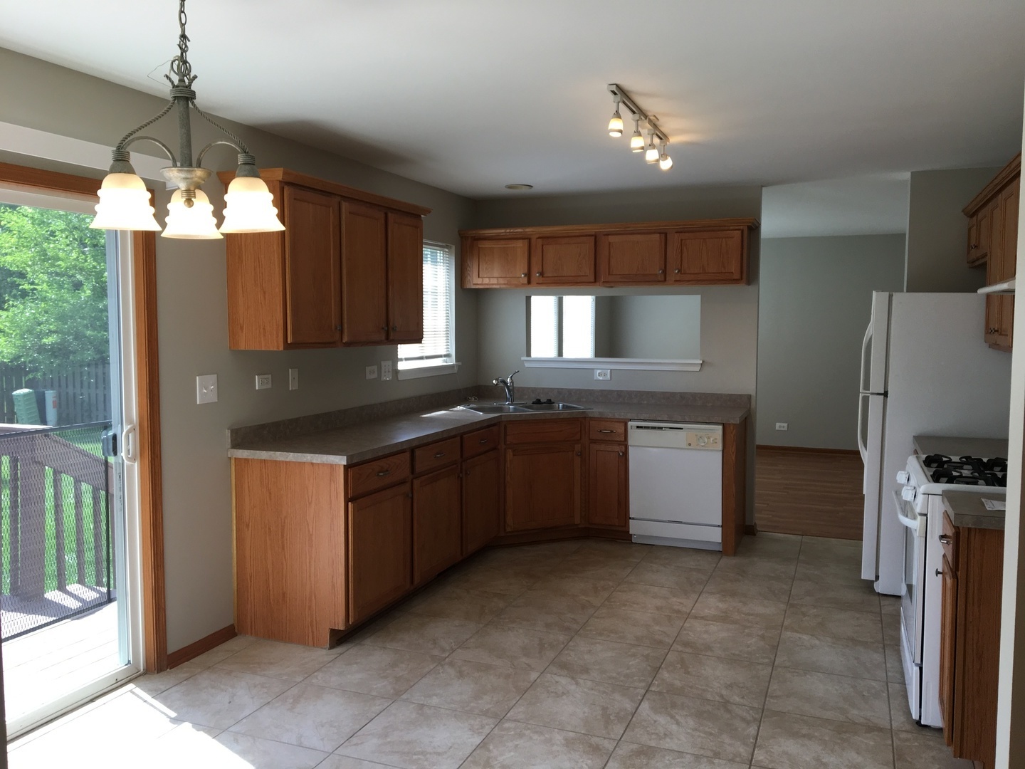 Undisclosed Address Round Lake, IL 60073 - Photo 6 of 29 a kitchen with granite countertop stainless steel appliances a sink stove and refrigerator
