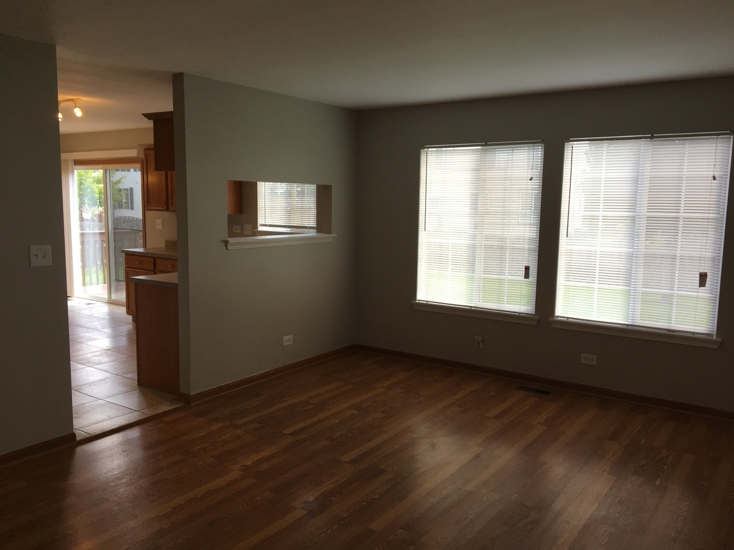 Undisclosed Address Round Lake, IL 60073 - Photo 7 of 29 an empty room with wooden floor and windows