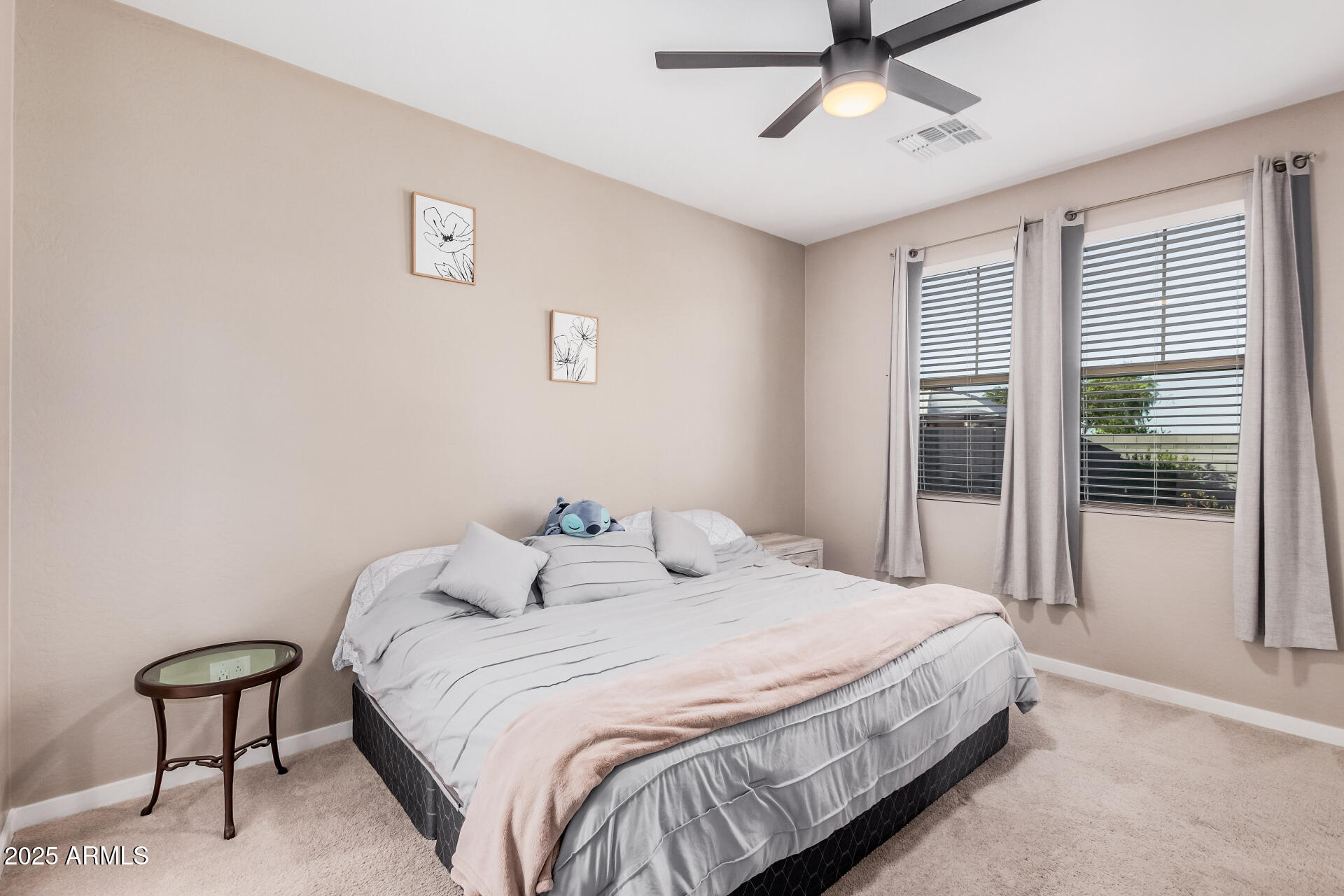 10736 West Chipman Road Tolleson, AZ 85353 - Photo 13 of 27 a bedroom with a bed and a lamp