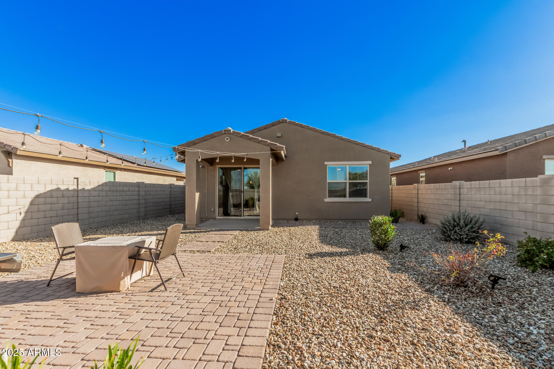 10736 West Chipman Road Tolleson, AZ 85353 - Photo 25 of 27 a front view of a house with patio