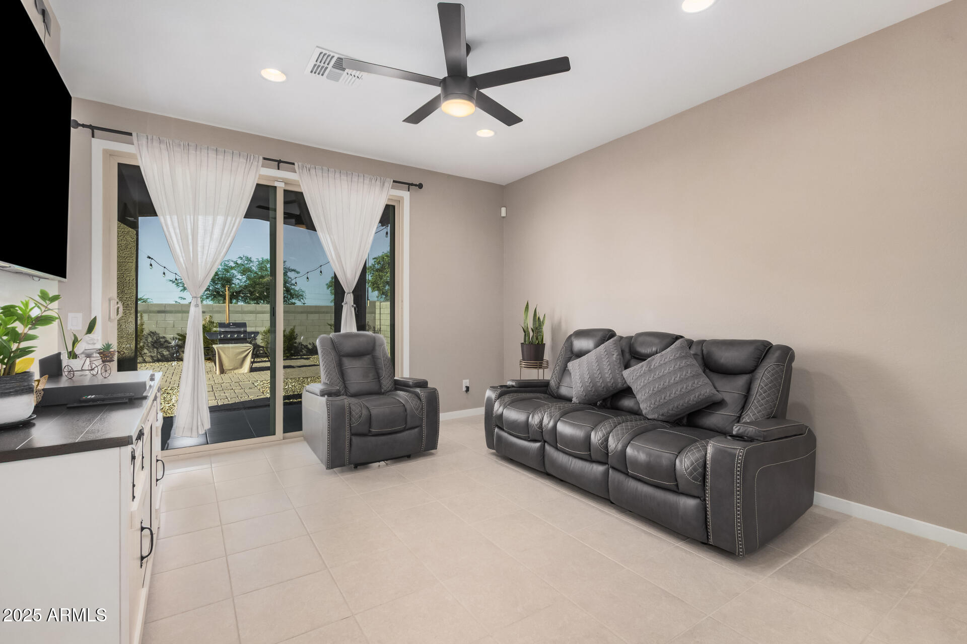 10736 West Chipman Road Tolleson, AZ 85353 - Photo 6 of 27 a living room with furniture and a flat screen tv