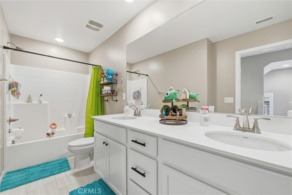 155 Spectacle Irvine, CA 92618 - Photo 18 of 40 a bathroom with a double vanity sink toilet and shower