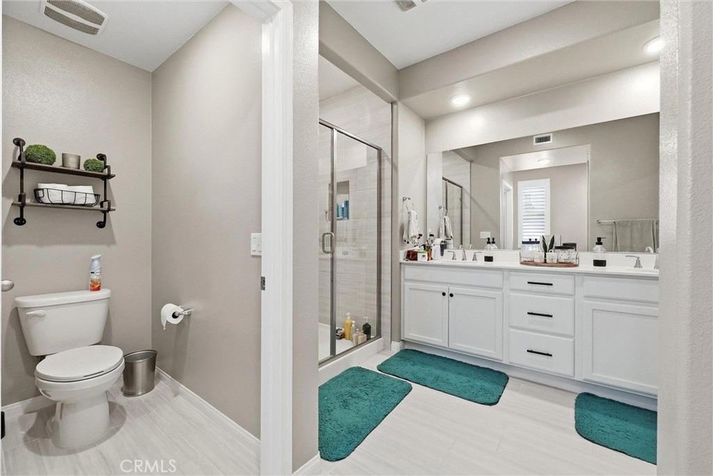 155 Spectacle Irvine, CA 92618 - Photo 28 of 40 a spacious bathroom with a toilet a sink and a mirror