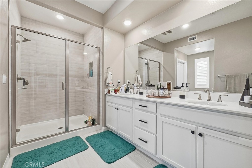 155 Spectacle Irvine, CA 92618 - Photo 29 of 40 a bathroom with a shower sink and mirror