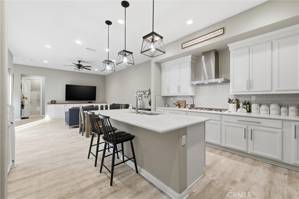155 Spectacle Irvine, CA 92618 - Photo 9 of 40 a kitchen with stainless steel appliances kitchen island granite countertop a sink a stove a dining table and chairs