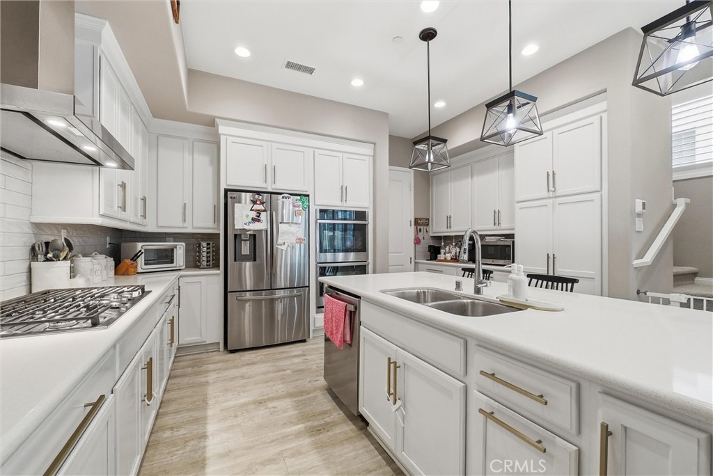155 Spectacle Irvine, CA 92618 - Photo 10 of 40 a kitchen with a sink refrigerator and cabinets