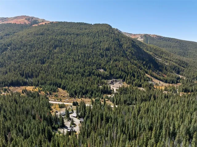 a view of a houses with a lush green hillside
