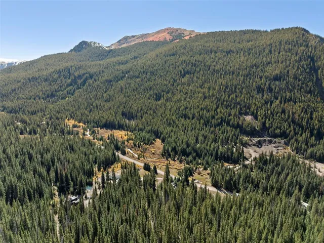 a view of a mountain in the distance in a field