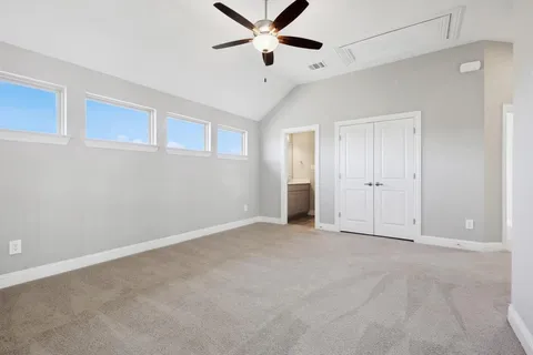 a view of an empty room with a ceiling fan