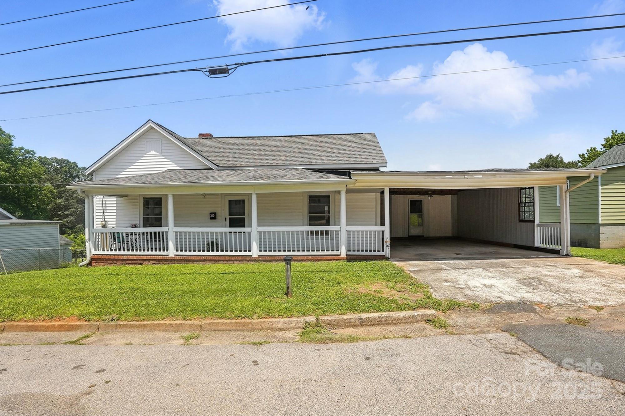 a front view of a house with a garden and yard