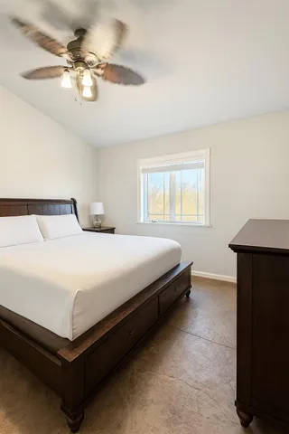 a bedroom with a bed and window