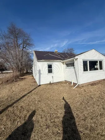 a backyard of a house with large trees