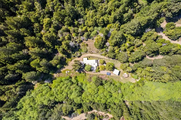 a backyard of a house with barbeque oven table and chairs