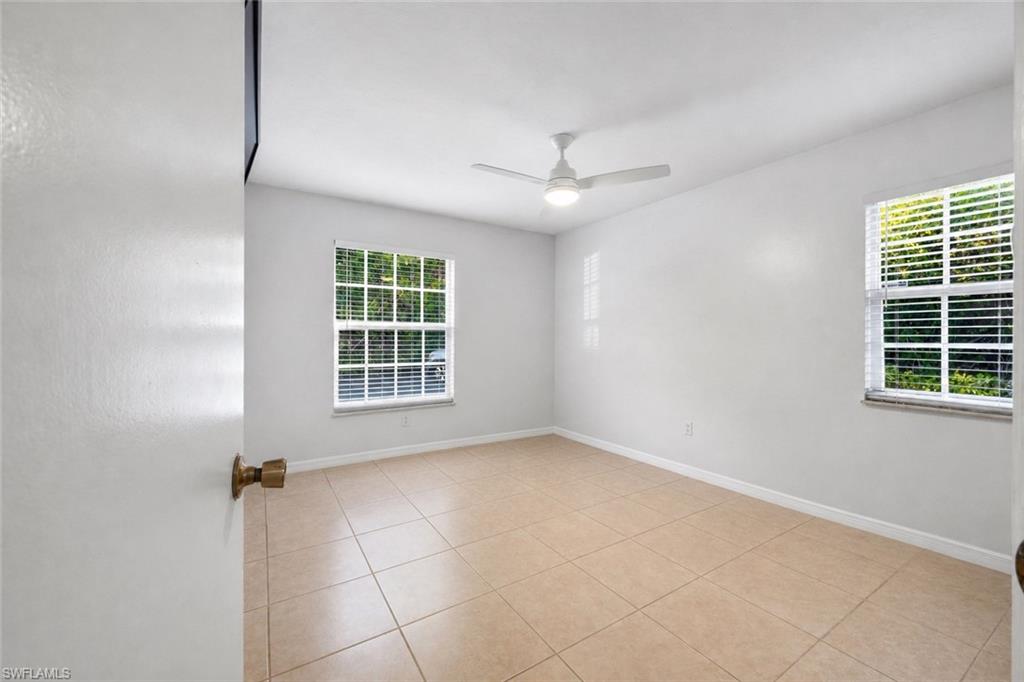 5737 Whitaker Road, Unit C101 Naples, FL 34112 - Photo 16 of 28 a view of an empty room with a window