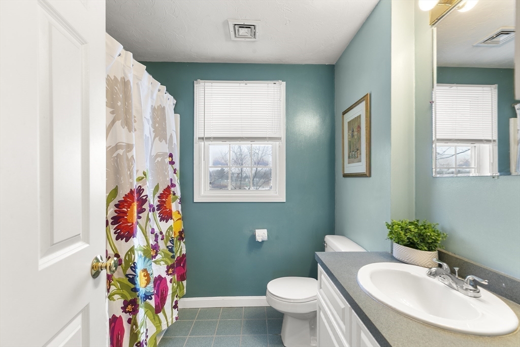 985 Trapelo Road, Unit 11 Waltham, MA 02452 - Photo 11 of 23 a bathroom with a toilet sink and mirror
