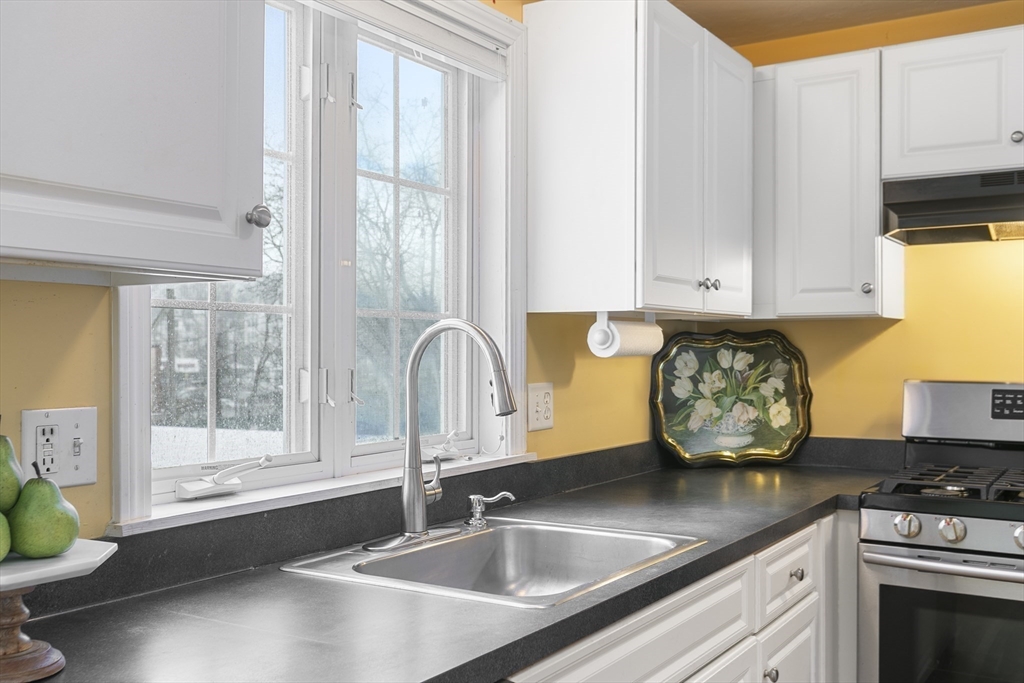 985 Trapelo Road, Unit 11 Waltham, MA 02452 - Photo 4 of 23 a kitchen with stainless steel appliances granite countertop a sink stove and cabinets