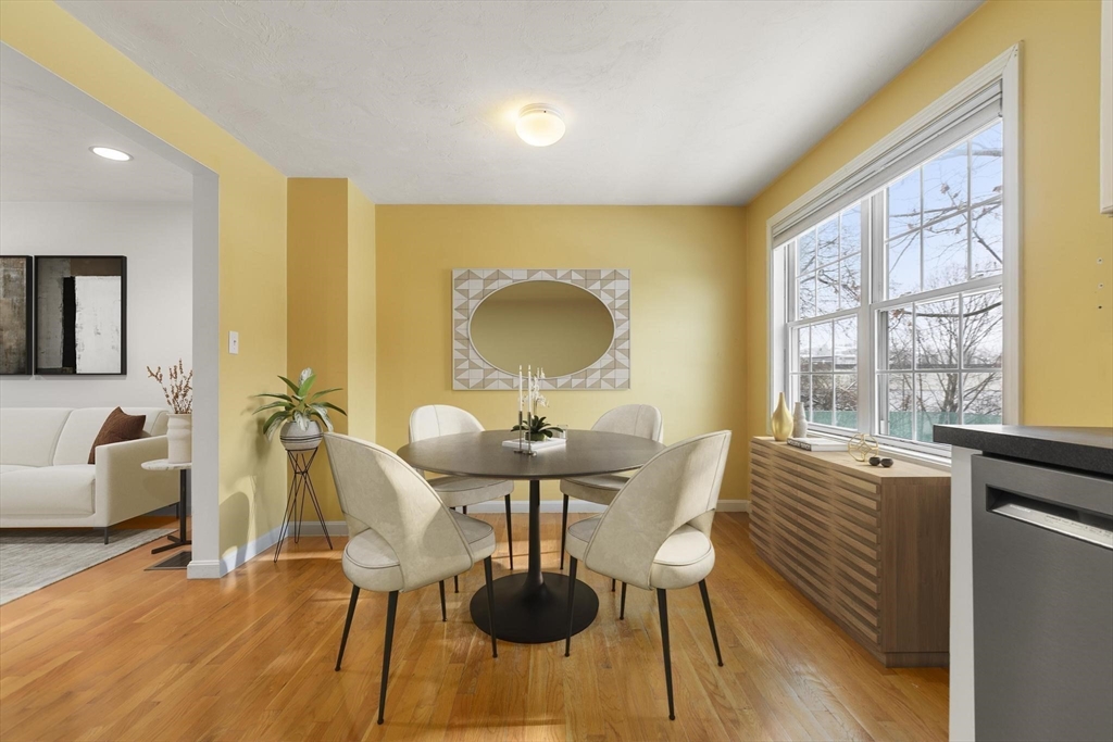 985 Trapelo Road, Unit 11 Waltham, MA 02452 - Photo 6 of 23 a view of a dining room with furniture window and wooden floor