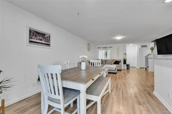 a view of a dining room with furniture and a flat screen tv