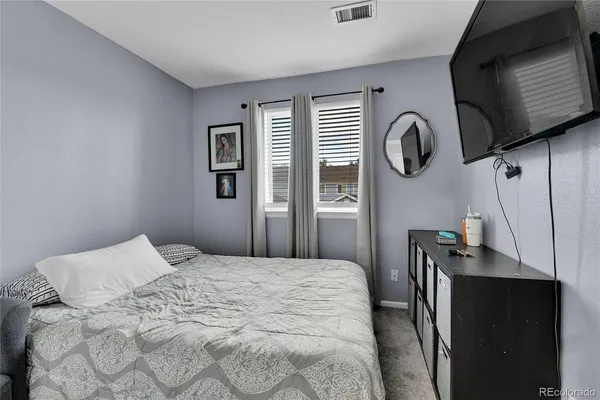 a bedroom with a bed and cabinets