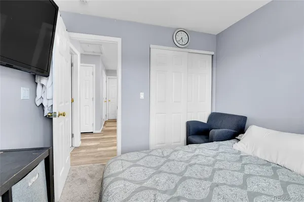 a bedroom with a bed window and couch