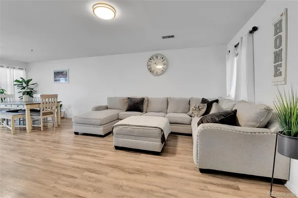 a living room with furniture and wooden floor