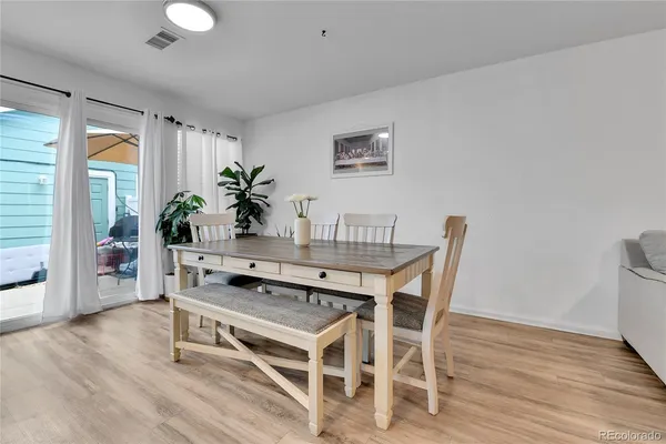a dining room with furniture and wooden floor