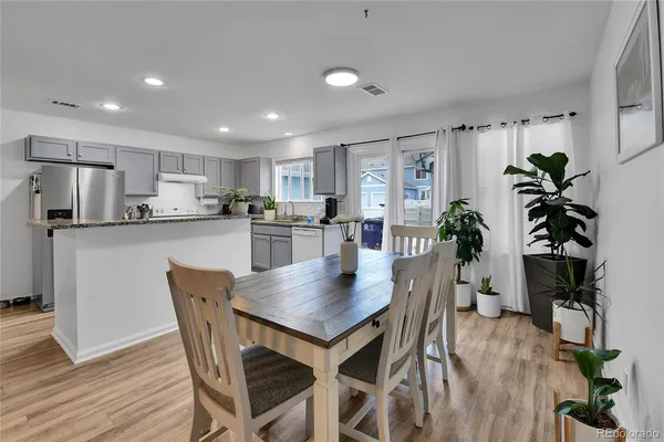 a view of a dining room with furniture and a potted plant