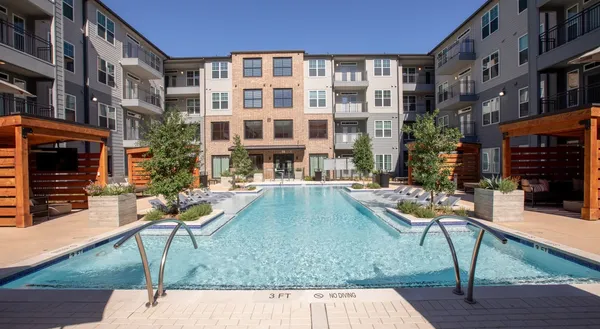 a view of a house with swimming pool and sitting area