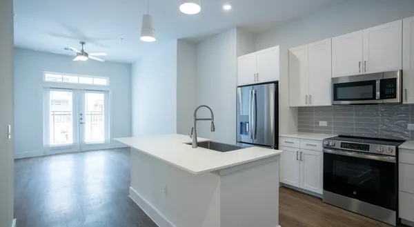 a kitchen with a sink stove and microwave