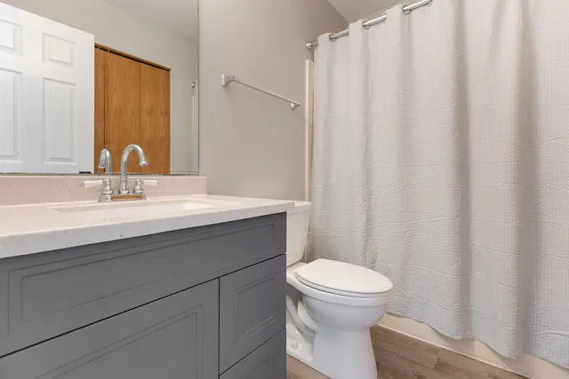a bathroom with a sink a toilet and a mirror