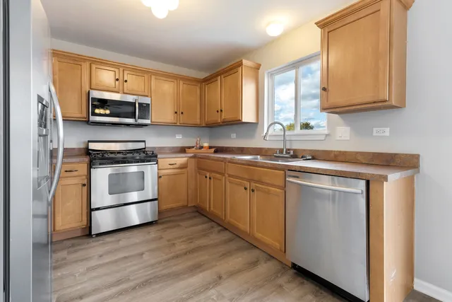a kitchen with granite countertop white cabinets and white stainless steel appliances